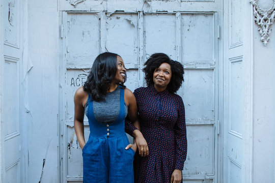 two sisters arm in arm