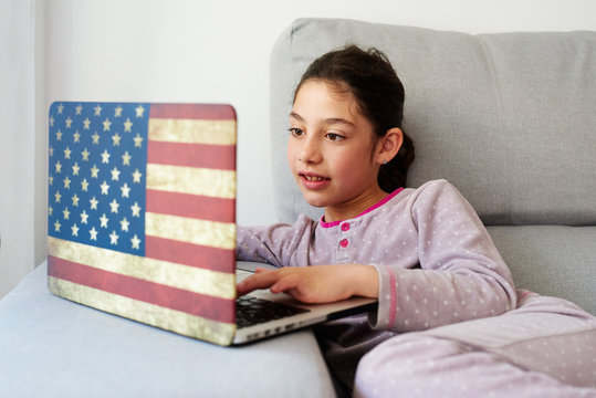 LIttle girl using her laptop at home