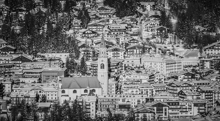 Black and white picture of the center and the church of Cortina D'Ampezzo, Italy.
