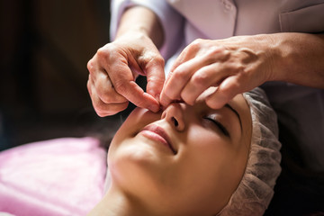 calm girl having spa facial massage in luxurious beauty salon