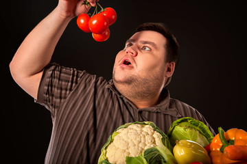 Diet fat man eating healthy food. Stop obesity concept. Health breakfast with vegetables . Male...