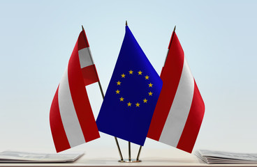 Two flags of Austria and European Union flag between