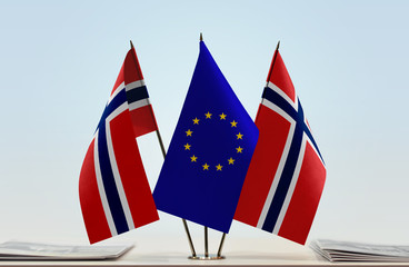 Two flags of Norway and European Union flag between