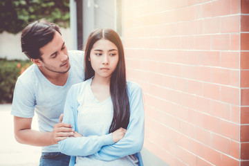 Portrait of couple asian young woman and man outdoor with relationship problem together, emotion unhappy concept.