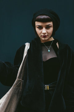 Cute gothic woman in front of black background