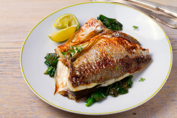 Dorado or dorada fish fillet with spinach, thyme and lime, horizontal