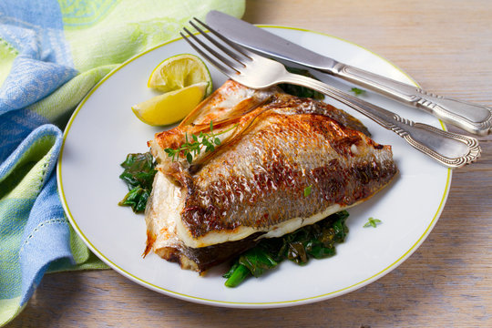 Dorado or dorada fish fillet with spinach, thyme and lime, horizontal