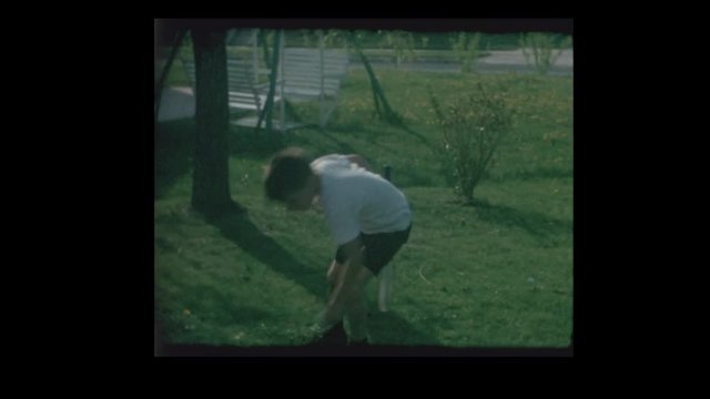 1966 Father and young son playing Badmitton in backyard