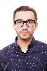 Obraz premium Portrait of hapy young smart man in glasses on white background