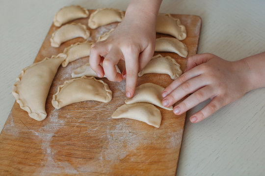 Closeup of boy's hands cooking dumplings