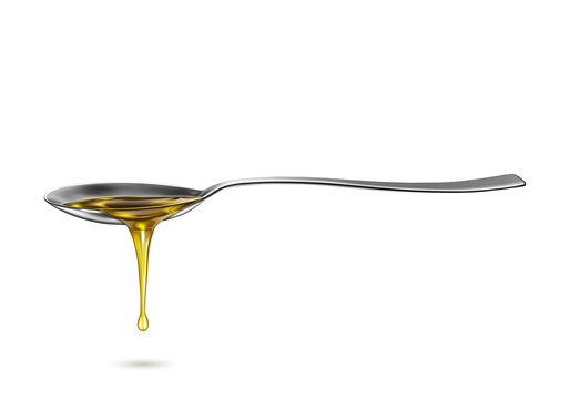 spoon with pouring drip oil isolated on white background
