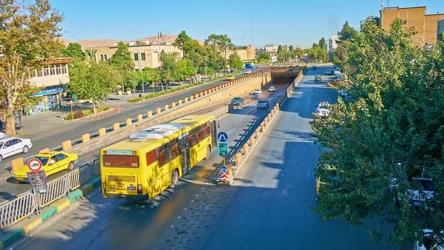 The traffic in Karim Khan Zand Boulevard and Zand underpass, with a view on Shohada square and Karim Khan Citadel on background, Shiraz.