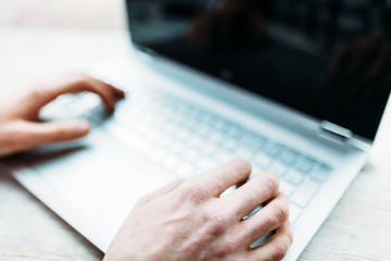 Hands close-up, typing on the laptop keyboard
