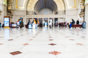 Closeup of red, orange tiled marble floor squares with bokeh in Union Station entrance in...