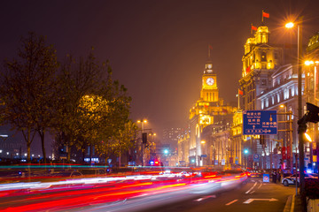 Fototapeta na wymiar Historical architecture on the bund of Shanghai with City lights and traffic lights at night, waterfront of the Huangpu River is a popular tourist destination of Asia. Shanghai, China