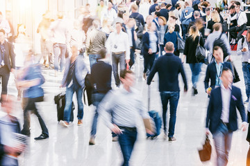 Large crowd of Blurred people at a trade fair floor