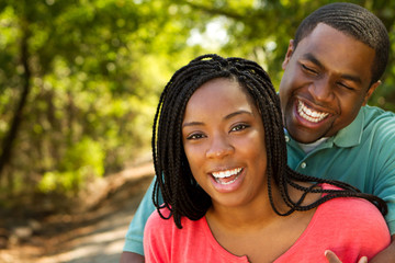 Obraz premium Beautiful happy couple smiling outside.