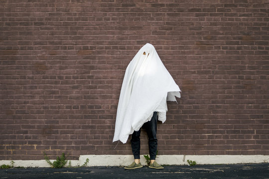 Man in Halloween Ghost Costume Made of Torn Bedsheets