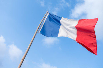 Naklejka na ściany i meble France flag of wave with bamboo flag pole and blue sky background