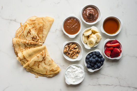 crepes with small condiment bowls