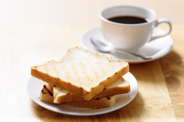 Breakfast with toast and coffee on wooden table