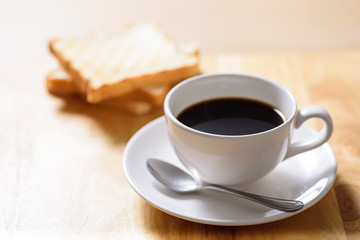 Breakfast with coffee and toast on wooden table