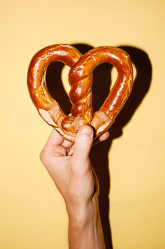 Hand holding heart-shaped pretzel