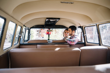 attractive man and woman inside their car