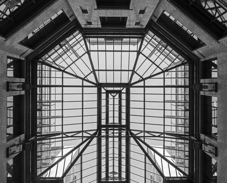 Black and white image of a glass roof spanning a court yard