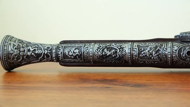 engraving on the steel of a musket in the form of soldiers