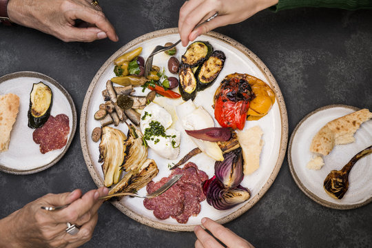 Two woman sharing an Italian appetiser plate