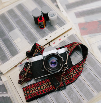 Vintage 35mm film camera with negatives and film canisters