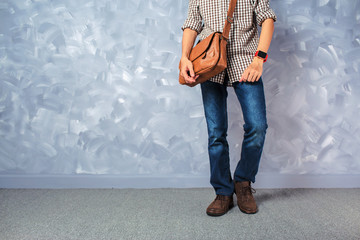 Vintage travelling men fashion with leather bag handsome thin man over loft concrete wall style.