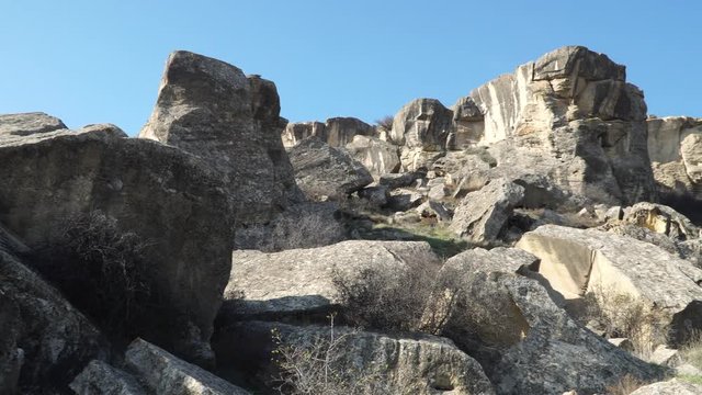 Gobustan is the national reserve of Azerbaijan. Petroglyphs of the ancient inhabitants of the planet. Ancient rock carvings, wild mountain landscapes, mountains and tourists.