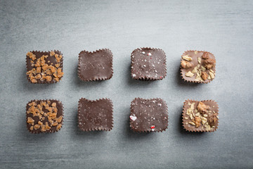 Several kinds of chocolate treats on a stone background.
