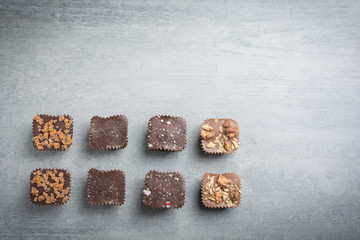 Several kinds of chocolate treats on a stone background.