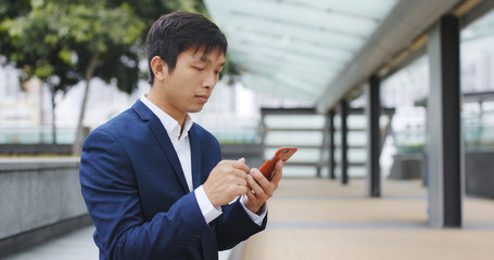 Businessman use of cellphone at outdoor