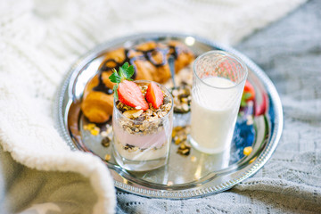Healthy breakfast with crunchy flakes, strawberry and glass of milk