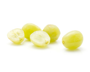 Green grape (Early Sweet or Grapaes variety) three whole berries and one cut in seedless half isolated on white background.