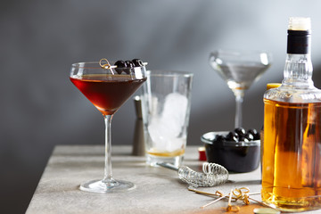 Manhattan cocktail with maraschino cherries on top.