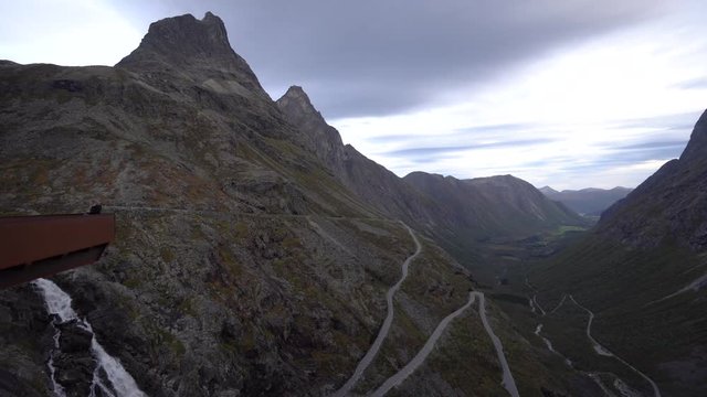 Girl takes photos and selfies at Trollstigen viewpoint in Norway