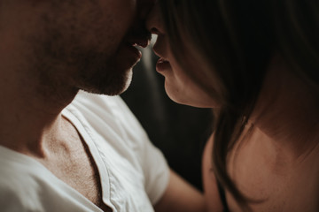 Young couple kissing in living room apartment