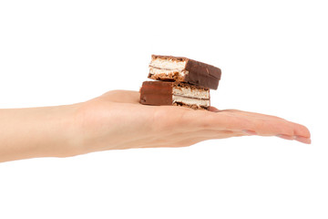 Chocolate cake candy biscuit milk in hand