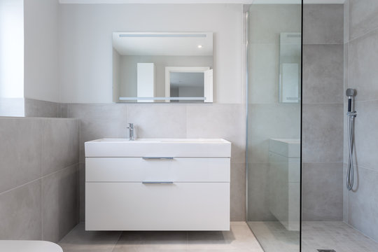 Close-up of a shower room showing integrated basin  and shower unit.