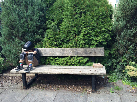 Sulking boy on bench