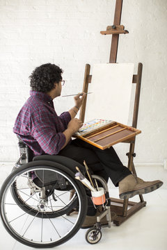 Man in wheel chair painting