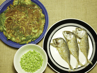 chicken omelet with local herb and thai mackerel fried on plate