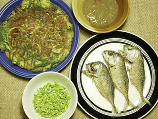 chicken omelet with local herb and thai mackerel fried on plate