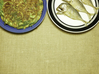 chicken omelet with local herb and thai mackerel fried on plate