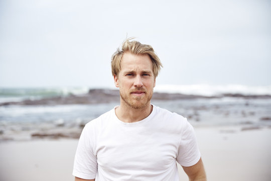 A blonde man on the beach